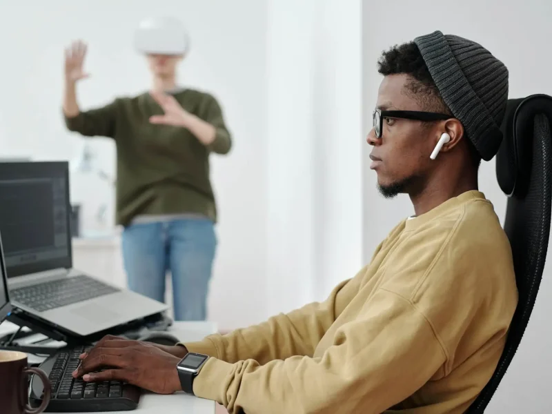 side-view-of-young-businessman-decoding-scanning data-while-looking-at-computer-screen